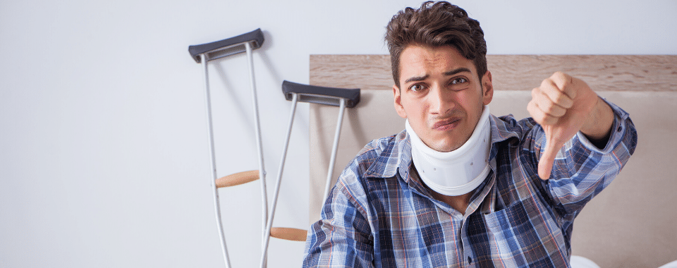 Disabled man in bed with crutches by his bedside