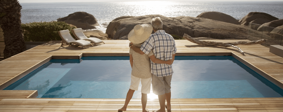 Couple holding hands by waterfront